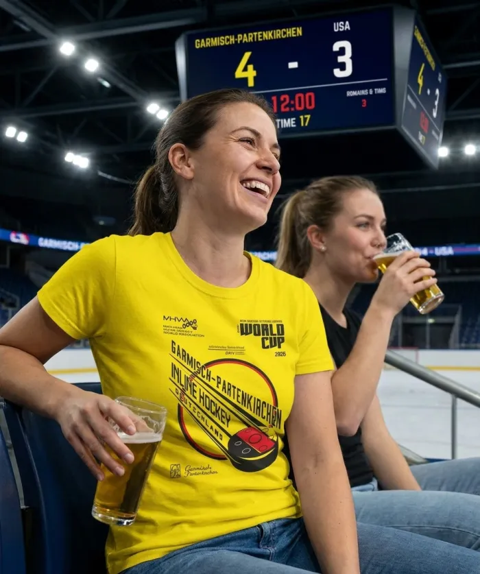 A fan in the stands wearing the yellow Garmisch-Partenkirchen World Cup tee