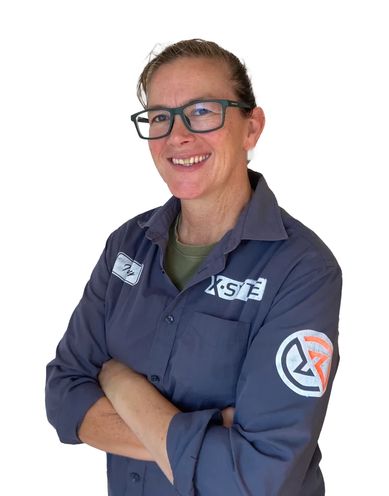 Tracy, founder of xSyte, arms folded and smiling